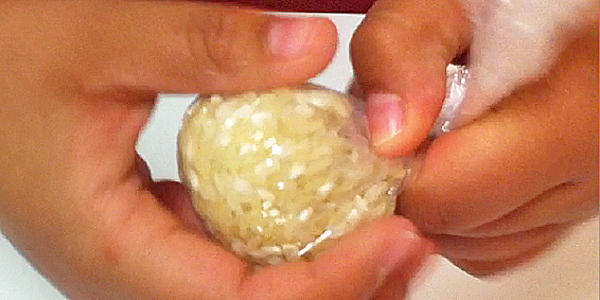 Formar una bola con el arroz en el papel film