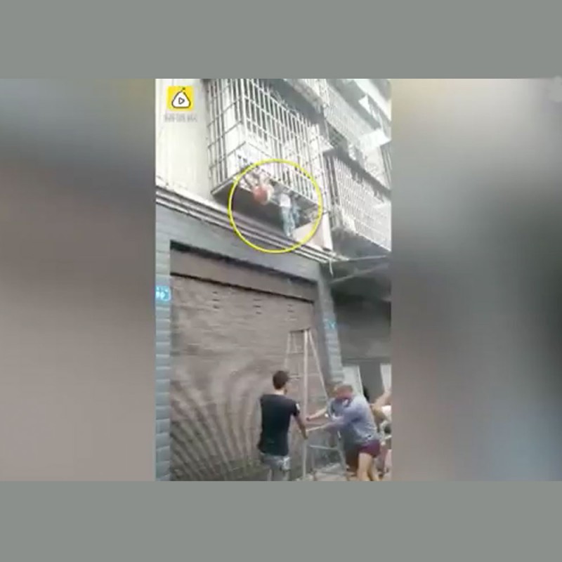 Imágenes de dos niños atrapados por la cabeza entre barrotes en una terraza