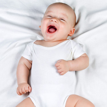 Risas de gemelos en brazos de su madre