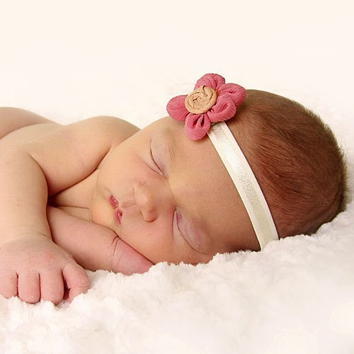 Una bebé durmiendo con su diadema