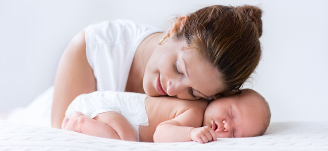 Primer Día de la Madre bebé agarrando el dedo de su madre