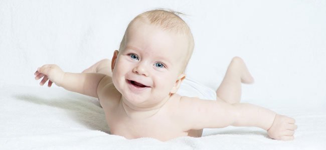Bebé boca abajo sonríe