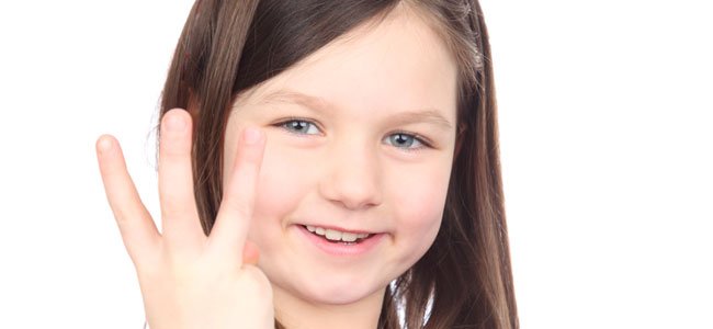 Niña enseña la tabla del tres Niña con el tres