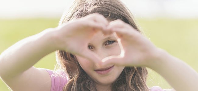 Cuidemos el corazón de nuestros hijos Niña hace corazón